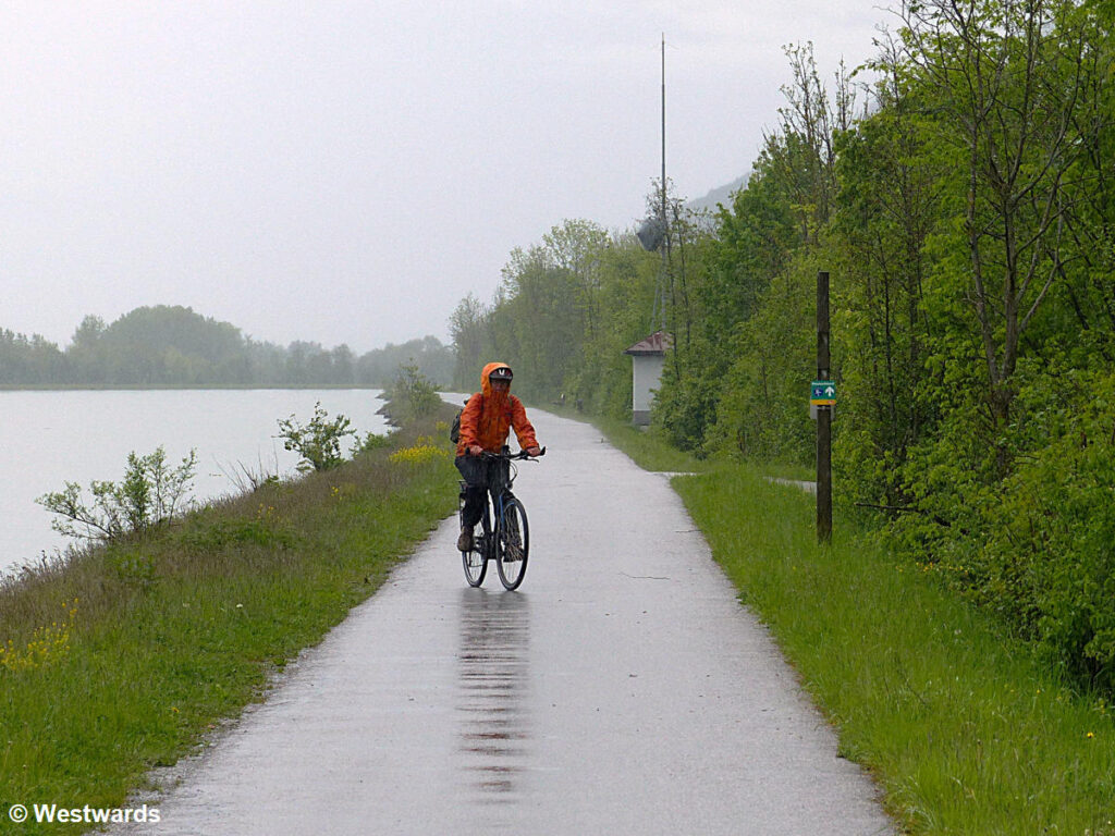 Travel writer Natascha riding a bike in pouring rain near Kufstein during our research trip