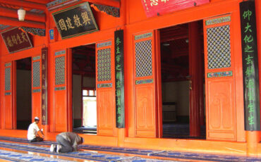 Men praying in a mosque in Xining that looks like a Chinese temple