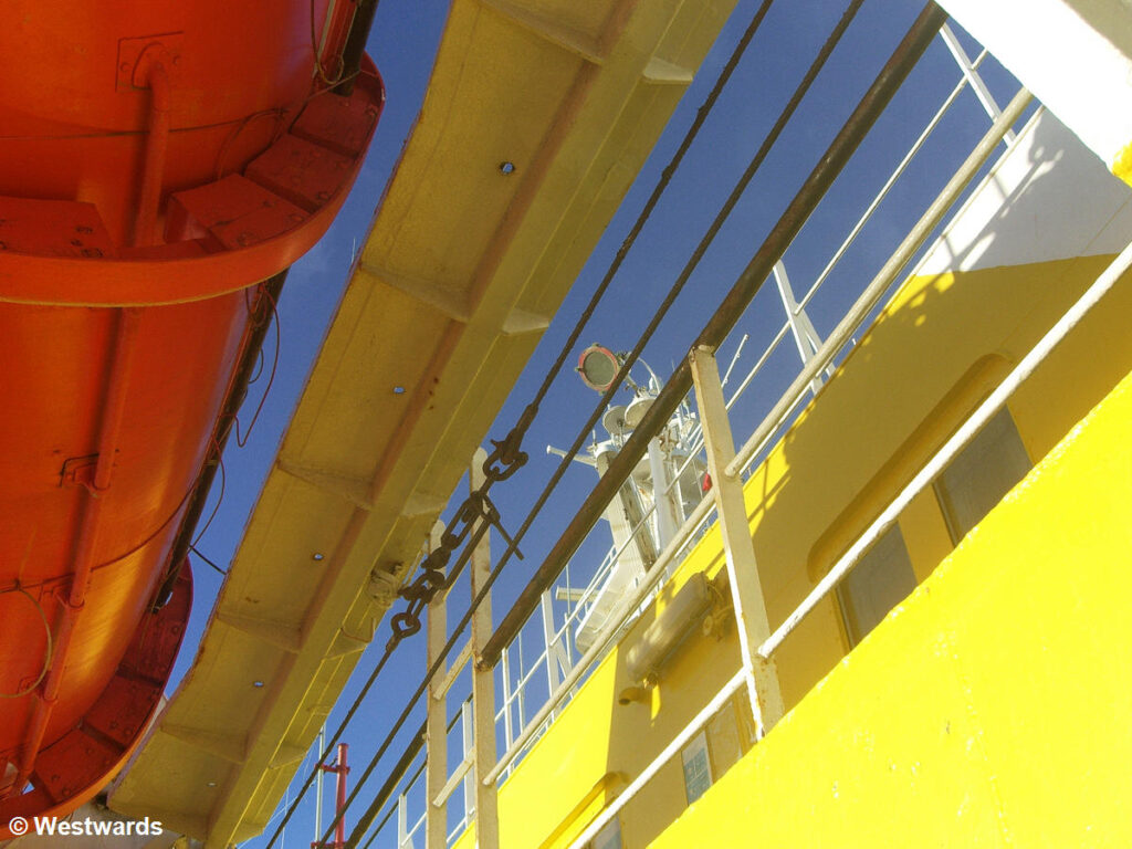 Yellow walls, red rescue boat, blue sky on the Navimag Ferry