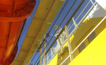 Yellow walls, red rescue boat, blue sky on the Navimag Ferry