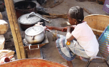 Girl cooking at an outdoor kitchen