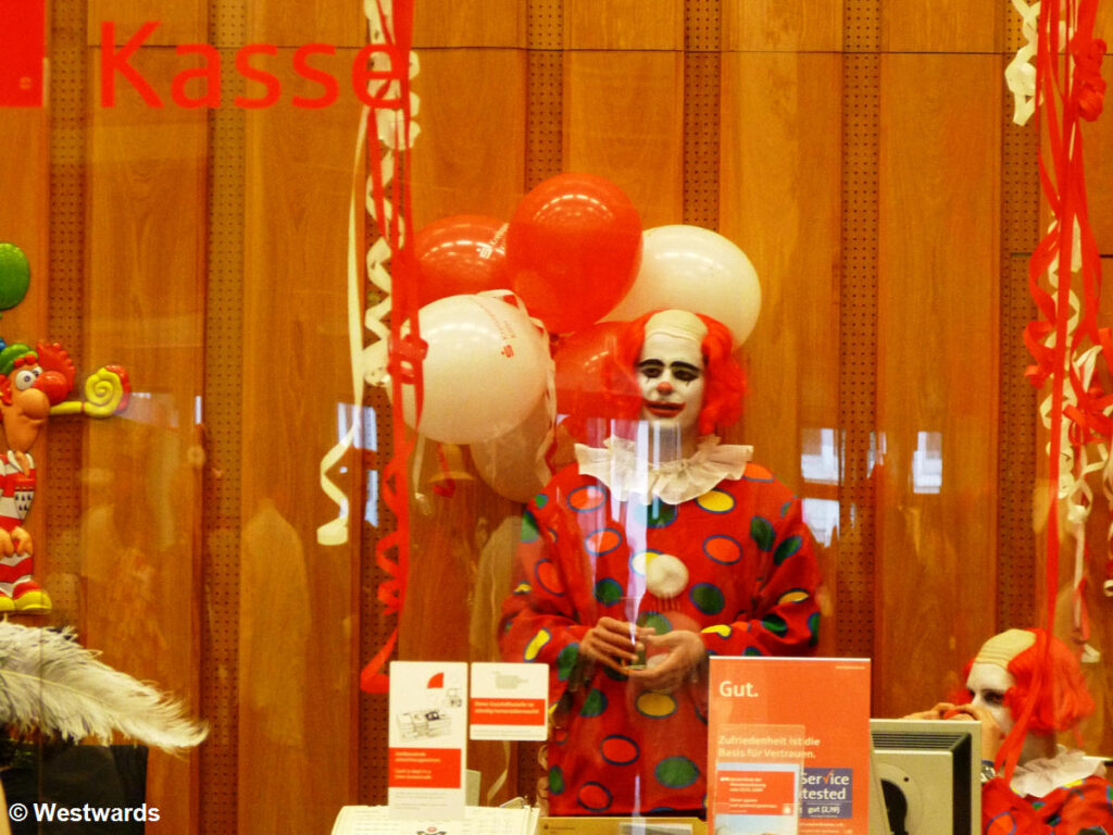 Clown in a branch bank during Cologne Carnival