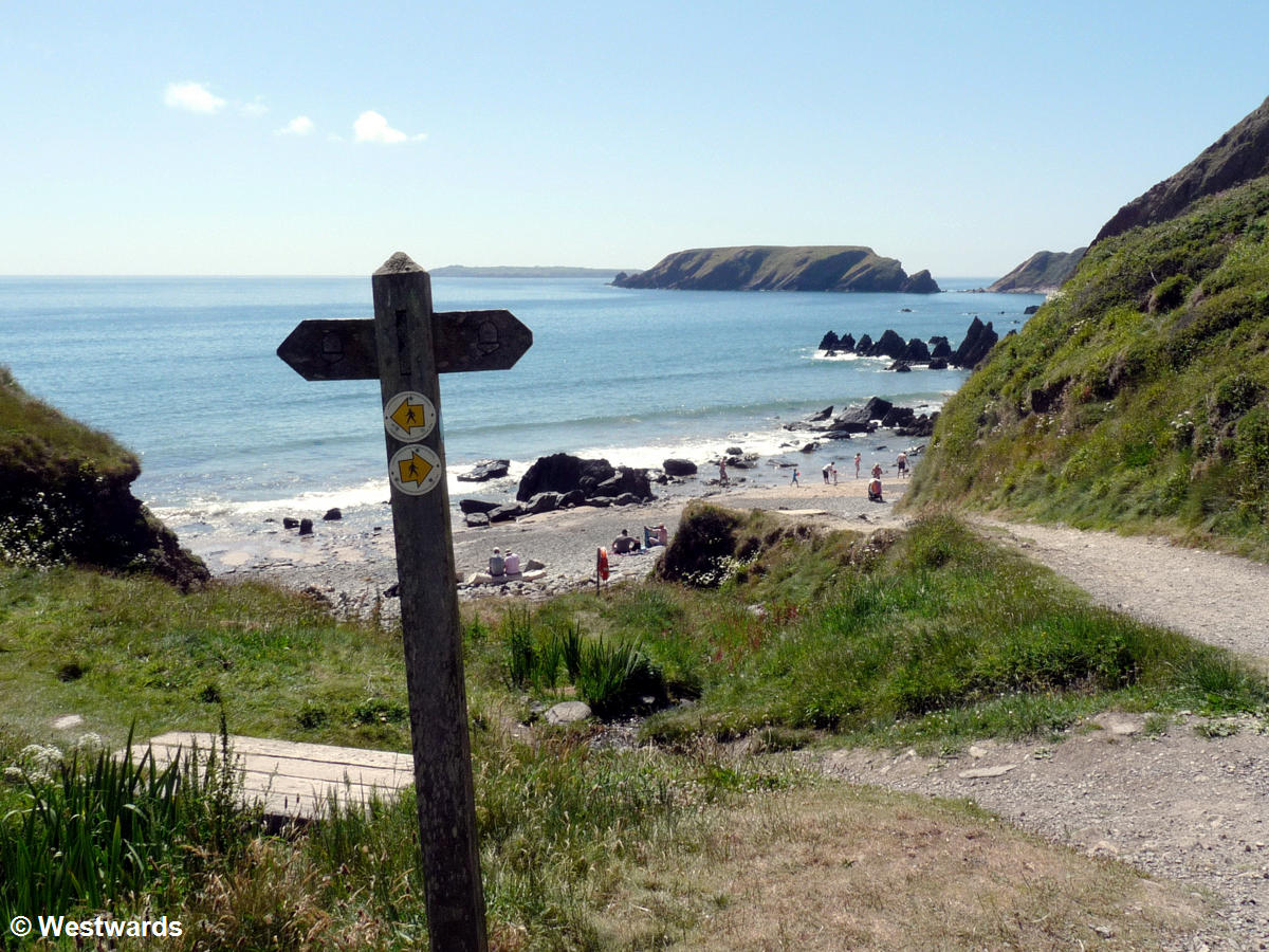 Pembrokeshire coastal path signage with beach