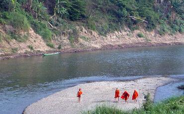 Monks after bathing in the river near Luang Prabang, Laos