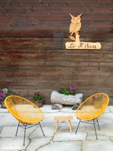 Stylish chairs on the terrace of a wooden chalet in Grimentz