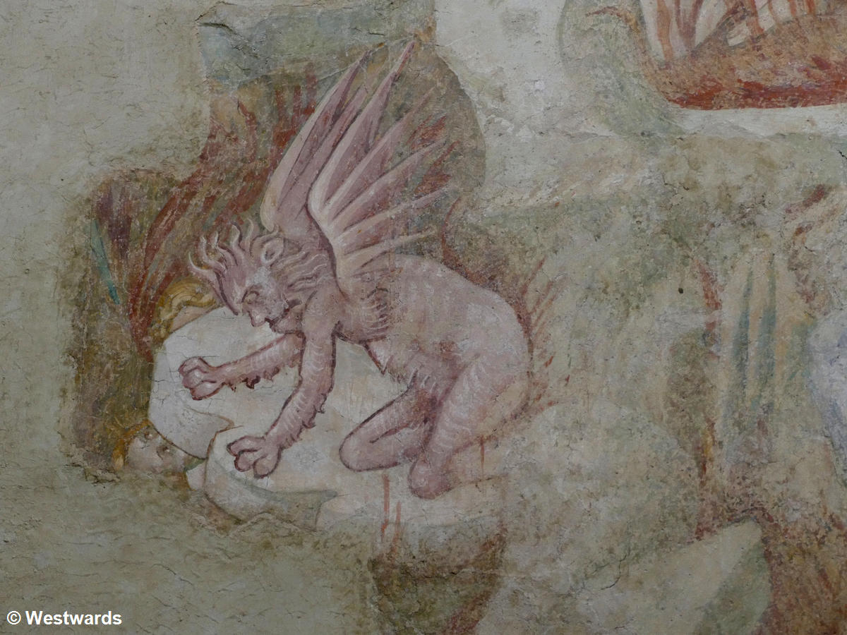A devil crushing a dammed soul in a fresco in San Lorenzo in Ponte
