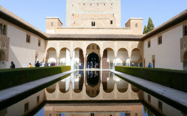 A part of the Nasrid Palace reflected in a water pool, Alhambra of Granada