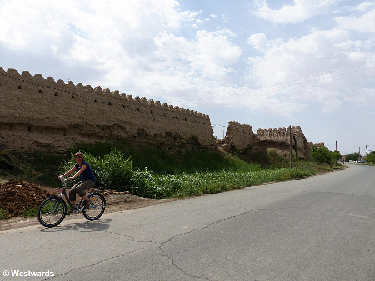 guidebook author cycling along Khiva's city walls