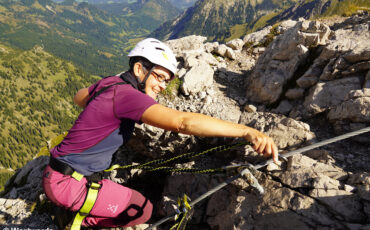 Westwards travel blogger Isa clipping into the safety cable on the Hindelanger Via Ferrata