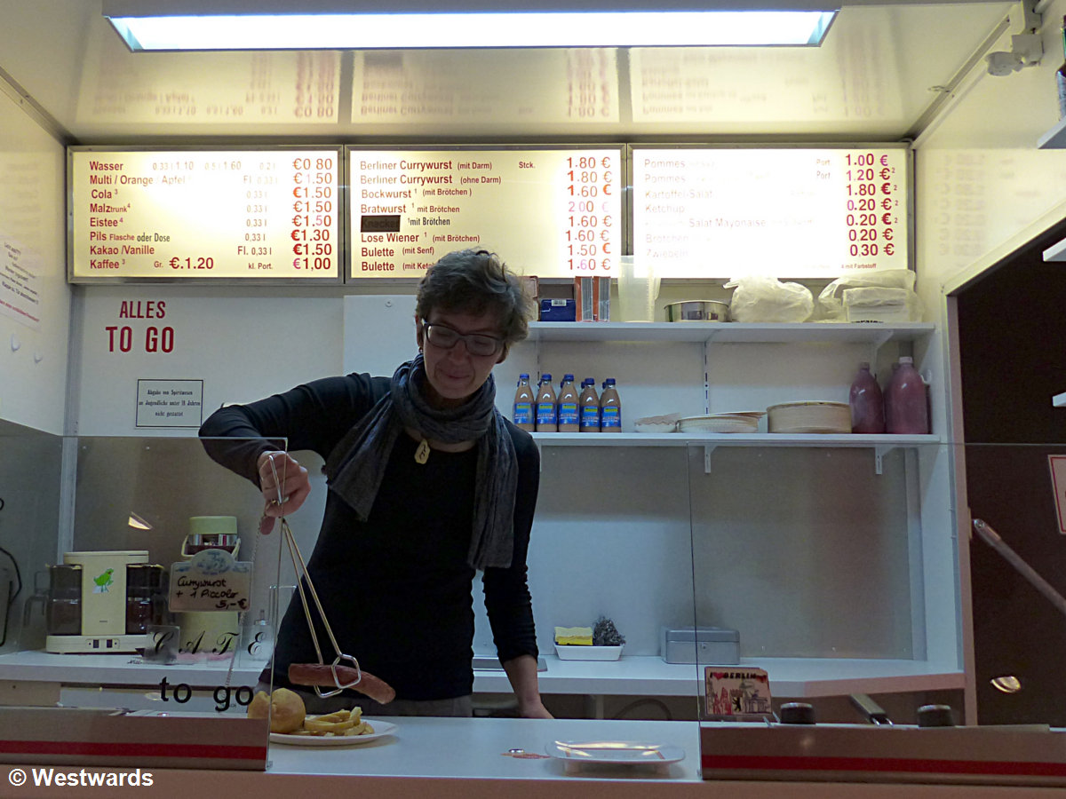 travel blogger Natascha trying her hands at serving Curry Wurst