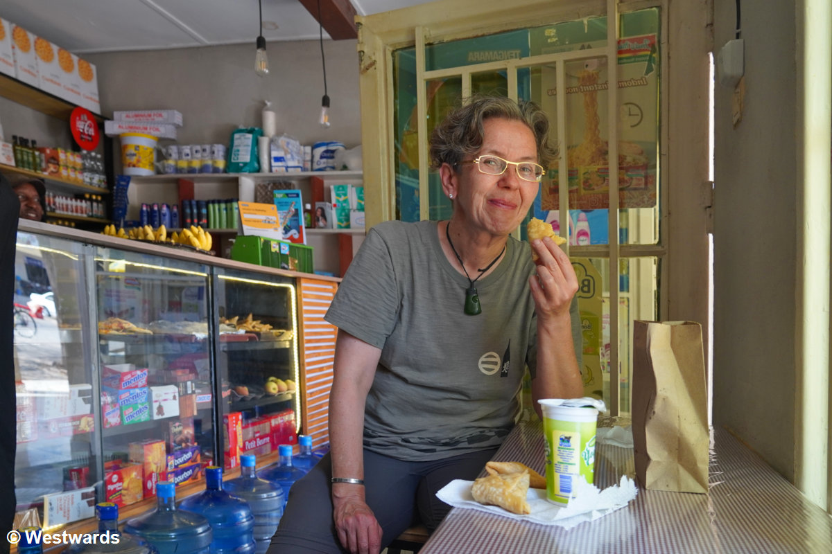 Sampling vegetarian snacks in a small shop in Nyanza
